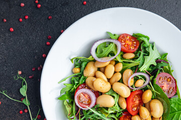 white bean salad , tomato, leaves lettuce mix fresh healthy meal food diet snack on the table copy space food background 