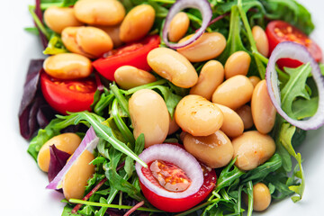 white bean salad , tomato, leaves lettuce mix fresh healthy meal food diet snack on the table copy space food background 