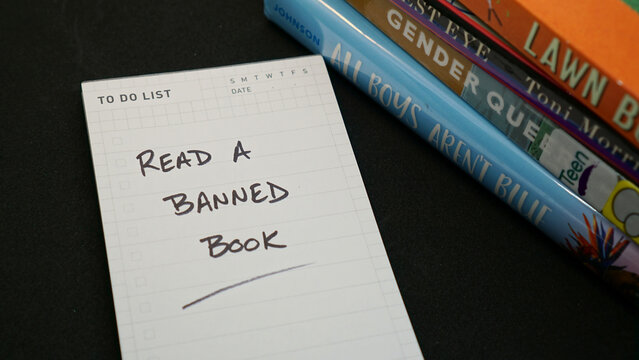 To do list reminder to read a banned book, along with a pile of books frequently on censorship lists.    