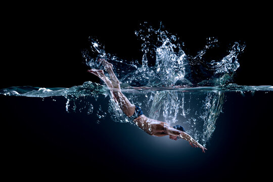 Professional man swimmer on a wave