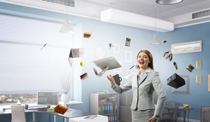 Young pretty businesswoman juggling with business items