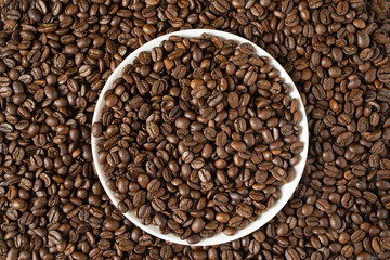 food background of coffee beans with a round saucer