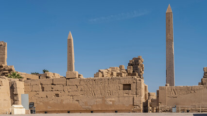 Hieroglyphs and carvings are visible on the dilapidated walls of the Karnak Temple in Luxor. Two...