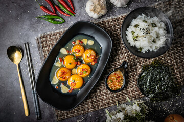 6 eggs with fish sauce in a black bowl