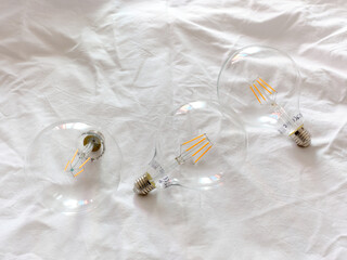 Three light bulbs on a white surface