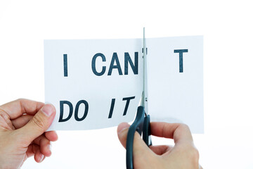 Closeup hand cutting paper for I can concept