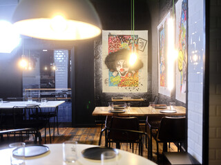 Interior view of a restaurant decorated with modern art paintings