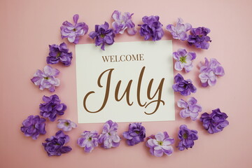 Fototapeta na wymiar Welcome July card typography text with flower bouquet on pink background