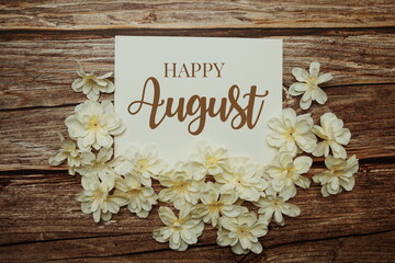 Happy August card typography text with flower bouquet on wooden background
