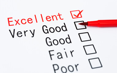 Pen checking the word Excellent in a survey