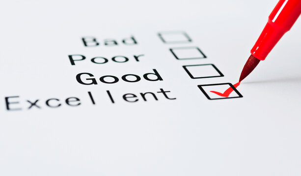 Pen checking the word Excellent in a survey