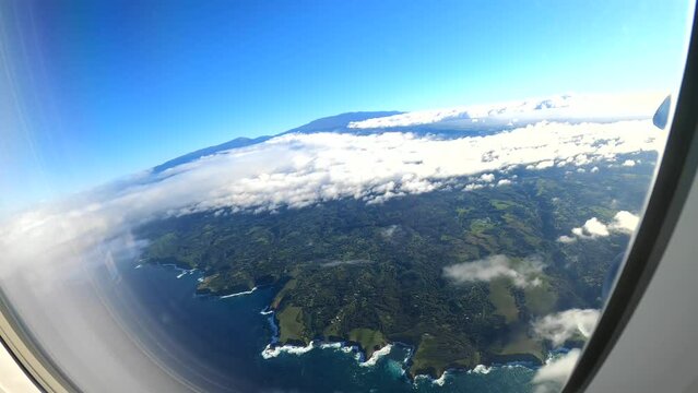 Flying over the lush and tropical island of MAUI. Window seat POV action cam footage in 4K.