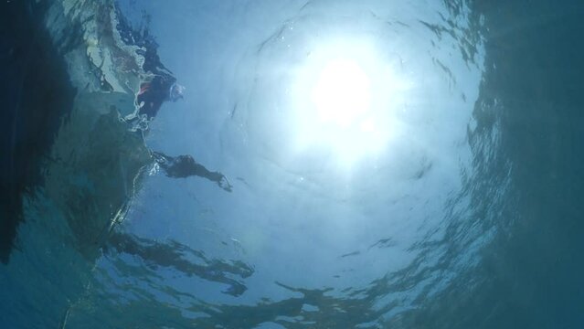 diver jumping in the water from boat underwater diving scenery slow motion ocean scenery sun beams and rays