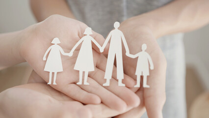 Children hands holding paper family cutout, family home, foster care, homeless charity support concept, family mental health, international day of families