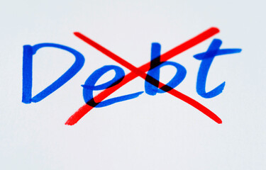 Drawing cross on word debt from white paper
