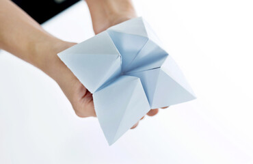 Hand in paper fortune teller isolated on white background