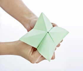 Hand in paper fortune teller isolated on white background