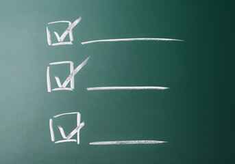 Checklist with tick on a chalkboard
