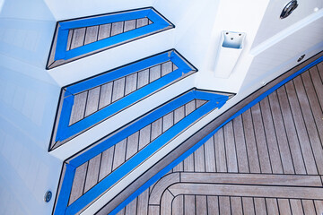 Teak stairs descending on a luxury yacht. The texture of the teak deck on the yacht, close-up. Teak...