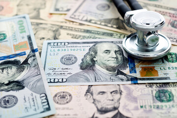 Stethoscope on heap of dollars