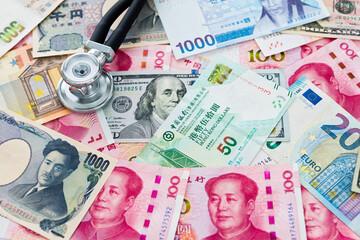 Stethoscope on many banknote, financial health check concept
