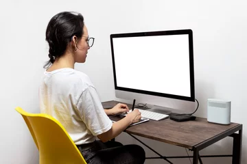 Fotobehang Mujer trabajando con tableta digital de diseño con pantalla en blanco.  © LiebreCromatica