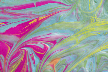 Fototapeta na wymiar Abstract fluid art texture. A multicolored pictorial fragment of a painting. Bright acrylic drawing of pink, yellow, purple, pale green and blue shades close-up. The concept of summer mood, flowering