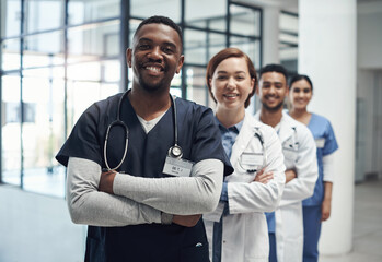 Not all heroes wear capes some wear labcoats. Shot of a group of medical staff together at work.