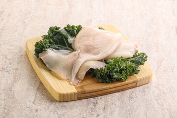 Raw squid over wooden board