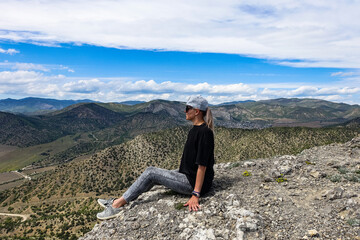 A girl on the background of landscapes of the Black Sea and the Crimean mountains on the Golitsyn trail. Crimea. 2021