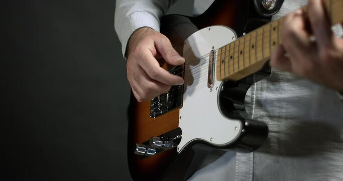 A Rock Guitarist Making Music On Stage. Playing Electric Guitar. Close Up Shot.