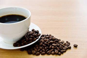Coffee and beans on wooden table