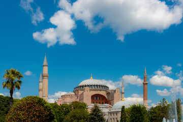 Fototapeta na wymiar Hagia Sophia in summer, Istanbul, Turkey. Hagia Sophia or Hagia Sophia is one of the city's best-known tourist attractions. Beautiful natural view of Hagia Sophia on a sunny and cloudy day. 