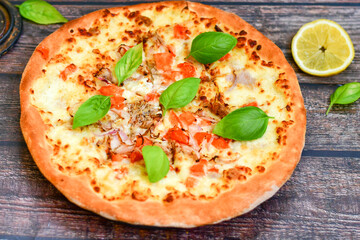   Home made Tuna fish   italian style pizza.   Parmesan cheese, mozzarella  , mushrooms,olives   cherry tomatoes and ,fresh basil
