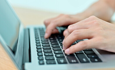 Woman hand typing on a laptop