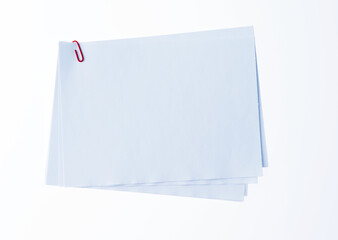 Blank paper with paperclip on white background