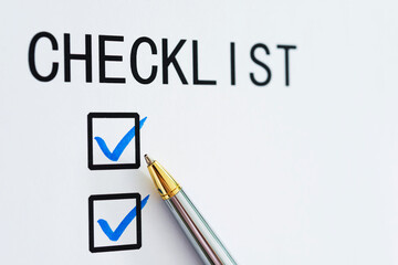 Checklist box on paper with checkmark and pen