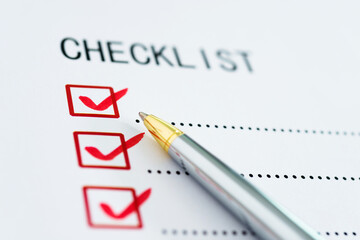 Checklist box on paper with checkmark and pen