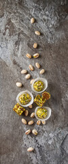 Eastern sweets. Turkish delight with pistachios in a vase. Dark gray stone background.