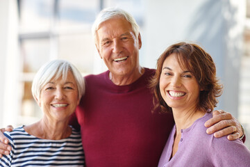 The most important women in my life. Portrait of a senior man standing beside his wife and daughter.