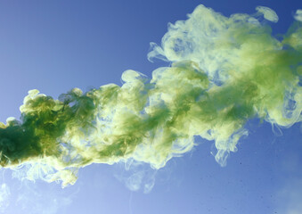 Fototapeta na wymiar Green smoke on a blue background.
