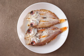 salted dried fish on a plate