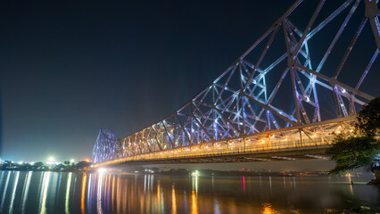 Fototapeta na wymiar Howrah bridge on the river Hooghly with the twilight sky. The cantilever bridge is considered the busiest bridge in India.