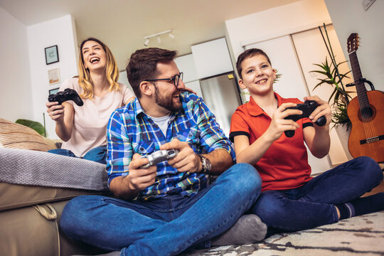Family playing video games at home