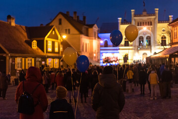 Hundreds of people holding balloons and flags participated at a "Stand With Ukraine" rally, against war and Russian aggression. Ukraine solidarity support in Kuldiga, Latvia.