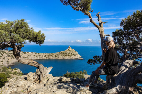 A girl on the background of a panorama of Cape Kapchik on the Galitsin trail. Black Sea Russia. 2021