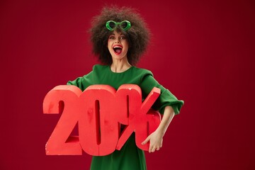 Pretty young female green dress afro hairstyle dark glasses twenty percent in hands color...
