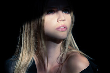Beautiful young woman portrait closeup on black. Sensual face of elegant female model in studio. Elegant lady.