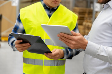 wholesale, logistic business and people concept - close up of warehouse worker and businessman with...