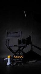 Black director chair and Clapper board or movie Clapperboard with megaphone on black background.use...